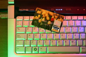 A credit card on top of a laptop keyboard. 