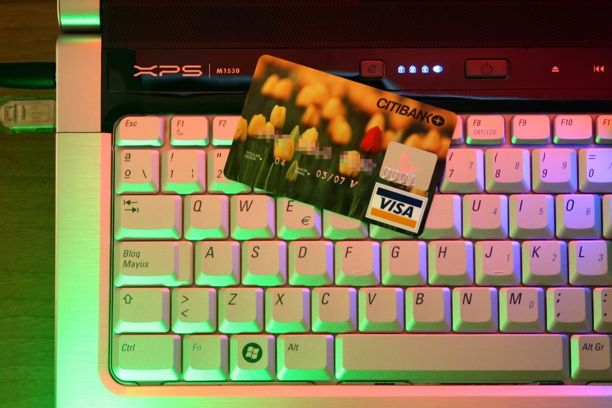 A credit card on top of a laptop keyboard.